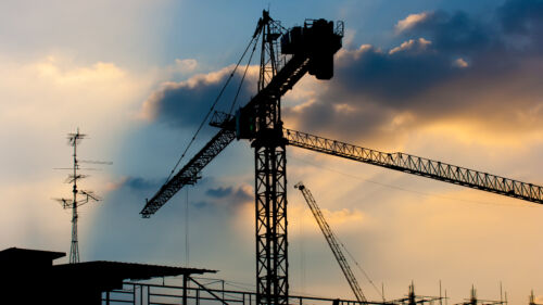 Industrial,Construction,Cranes,Silhouettes,Over,Sunset.